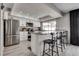 Modern kitchen featuring stainless steel appliances, a breakfast bar, and lots of natural light at 2532 Whippoorwill Ln, Las Vegas, NV 89121