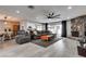 Open concept living room showcasing updated flooring, a stone fireplace, access to the kitchen, and an outdoor area at 2532 Whippoorwill Ln, Las Vegas, NV 89121
