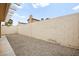 A low-maintenance backyard featuring a gravel ground cover and block wall fencing at 2793 Sandyfalls Way, Las Vegas, NV 89142