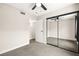 Bedroom with carpet, mirrored closet doors, and a ceiling fan at 2793 Sandyfalls Way, Las Vegas, NV 89142