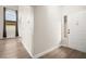 Hallway with wood floors leading to a living area with fireplace at 2793 Sandyfalls Way, Las Vegas, NV 89142