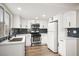 Bright kitchen featuring stainless steel appliances, white cabinetry, and modern countertops at 2793 Sandyfalls Way, Las Vegas, NV 89142