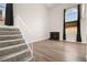 Bright living room with wood floors, modern fireplace, and large arched window at 2793 Sandyfalls Way, Las Vegas, NV 89142