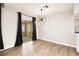 Modern living area with new light fixture and sliding glass doors to the exterior at 2793 Sandyfalls Way, Las Vegas, NV 89142