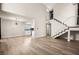 Bright open floor plan featuring hardwood floors, modern lighting, and access to the kitchen at 2793 Sandyfalls Way, Las Vegas, NV 89142