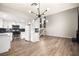Modern kitchen flows into the living area with hardwood floors and a fireplace at 2793 Sandyfalls Way, Las Vegas, NV 89142
