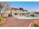 Backyard featuring a swimming pool, shed, gravel landscaping, and the exterior of the two-story home at 2916 W Oakey Blvd, Las Vegas, NV 89102