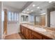 Bright bathroom featuring a double vanity, granite countertop, and shuttered window at 2916 W Oakey Blvd, Las Vegas, NV 89102