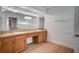 Bathroom with double sink vanity, wood cabinets, and granite countertops at 2916 W Oakey Blvd, Las Vegas, NV 89102