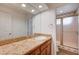 Bathroom with granite countertop, a framed mirror, and a glass door shower at 2916 W Oakey Blvd, Las Vegas, NV 89102