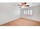 Minimalist bedroom with ceiling fan, white walls and hardwood floors at 2916 W Oakey Blvd, Las Vegas, NV 89102