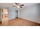 Bedroom with wood-look floors, ceiling fan, and a closet with open shelves at 2916 W Oakey Blvd, Las Vegas, NV 89102