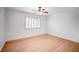 Bedroom featuring white walls, wooden floors, and a window with white shutters and a ceiling fan at 2916 W Oakey Blvd, Las Vegas, NV 89102