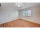 Bedroom features new hardwood floors, a modern chandelier, and shuttered window at 2916 W Oakey Blvd, Las Vegas, NV 89102