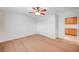 Bedroom boasts light wood floors, white walls, ceiling fan, closet, and adjacent room with built-in cabinetry at 2916 W Oakey Blvd, Las Vegas, NV 89102