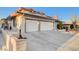 Spacious three-car garage with an expansive driveway and partial view of the front exterior at 2916 W Oakey Blvd, Las Vegas, NV 89102