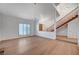 Bright living room featuring wood floors, two chandeliers, staircase, and an open-concept design at 2916 W Oakey Blvd, Las Vegas, NV 89102