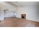 Spacious living room featuring hardwood floors, brick fireplace, and elegant light fixtures at 2916 W Oakey Blvd, Las Vegas, NV 89102