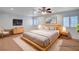 Staged main bedroom with hardwood floors, ceiling fan, and a comfy bed at 2916 W Oakey Blvd, Las Vegas, NV 89102