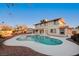 A backyard view of a two-story home featuring a large, in-ground swimming pool and covered patio area at 2916 W Oakey Blvd, Las Vegas, NV 89102
