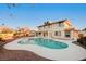 View of the backyard showcasing a private swimming pool, patio, and the rear exterior of the two-story home at 2916 W Oakey Blvd, Las Vegas, NV 89102