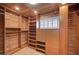 Spacious walk-in closet with custom wood shelving, drawers, cabinets, and a window at 2916 W Oakey Blvd, Las Vegas, NV 89102