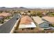 Expansive aerial view of a single-story home with a covered patio and views of the surrounding neighborhood and mountains at 2970 Strathspey Ct, Henderson, NV 89044