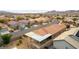 Aerial shot of a single-Gathering home featuring a covered patio, desert landscaping and a view of the surrounding community at 2970 Strathspey Ct, Henderson, NV 89044