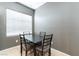 Cozy dining area featuring a dark wood table and upholstered chairs near a bright window at 2970 Strathspey Ct, Henderson, NV 89044