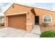 Inviting front of home with two-car garage, xeriscaping and covered entry at 2970 Strathspey Ct, Henderson, NV 89044