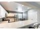 Well-lit kitchen with white cabinets, stainless steel appliances, and breakfast bar at 2970 Strathspey Ct, Henderson, NV 89044