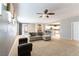 Large, open living room with neutral carpet, and a view of the kitchen at 2970 Strathspey Ct, Henderson, NV 89044