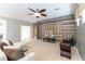Open living room with accent wall and neutral carpet, bathed in natural light at 2970 Strathspey Ct, Henderson, NV 89044