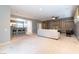 Spacious living room featuring carpet floors, ceiling fan, and open to kitchen area at 2970 Strathspey Ct, Henderson, NV 89044