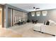 Cozy living room with neutral colors, modern ceiling fan and unique accent wall at 2970 Strathspey Ct, Henderson, NV 89044