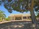 Exterior of home with covered patio area surrounded by desert landscape at 3117 Brightridge Dr, Las Vegas, NV 89134