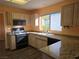 Well-equipped kitchen with wood cabinetry, granite counters, and black appliances at 3117 Brightridge Dr, Las Vegas, NV 89134