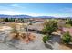 Wide aerial view of a home in a quiet, residential neighborhood with mountain views at 3140 Unicorn Ave, Pahrump, NV 89048