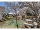 Landscaped backyard retreat with mature trees and stone seating area at 3140 Unicorn Ave, Pahrump, NV 89048