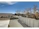 View from the balcony with a flat roof, wooden fence, and bare trees at 3140 Unicorn Ave, Pahrump, NV 89048