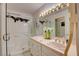 Bathroom featuring a shower, tile countertop, and vanity lighting at 3140 Unicorn Ave, Pahrump, NV 89048