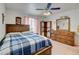 Bedroom with ceiling fan, dresser and window with curtains at 3140 Unicorn Ave, Pahrump, NV 89048