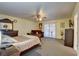 Spacious bedroom featuring a ceiling fan, natural light, and carpeted floors at 3140 Unicorn Ave, Pahrump, NV 89048