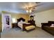 Large primary bedroom with carpeted floors, ceiling fan, and ensuite access at 3140 Unicorn Ave, Pahrump, NV 89048