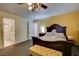Bedroom with carpeted floors, ceiling fan, and ensuite access at 3140 Unicorn Ave, Pahrump, NV 89048
