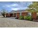 Brick ranch-style home showcasing mature landscaping and a well-maintained gravel front yard at 3140 Unicorn Ave, Pahrump, NV 89048