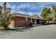 Brick home featuring lush landscaping and a well-maintained front yard at 3140 Unicorn Ave, Pahrump, NV 89048