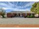 Charming brick home featuring desert landscaping and gravel driveway at 3140 Unicorn Ave, Pahrump, NV 89048
