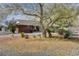 Single-story brick house featuring drought-tolerant landscaping, including cacti and mature trees at 3140 Unicorn Ave, Pahrump, NV 89048