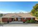 Inviting brick home featuring a cozy front porch with chairs and desert-friendly landscaping at 3140 Unicorn Ave, Pahrump, NV 89048